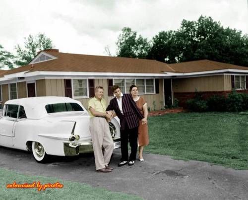 BIO Elvis with Gladys Vernon in yard of Audubon Drive leaning on back of BEAUTIFUL white lincoln or caddy 1956